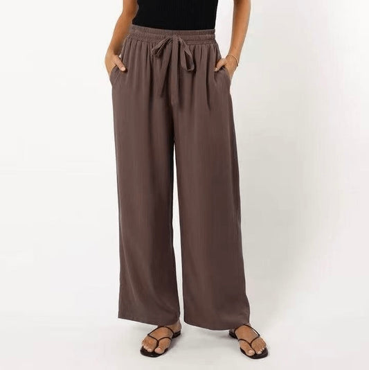 Brown wide-leg pants worn by a person on a white background
